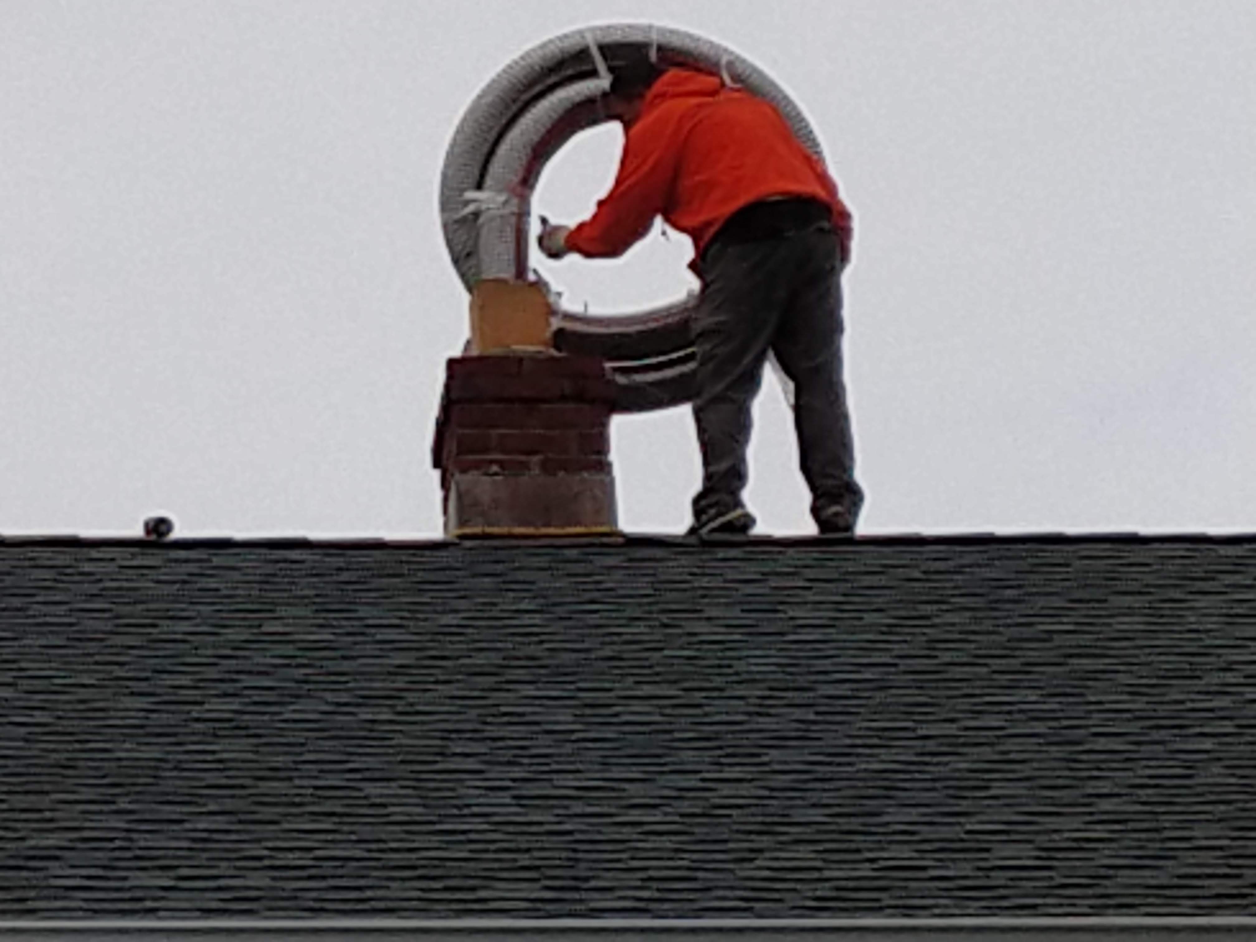 Flexible stainless chimney liner being installed in Levittown, New York